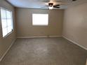 Bright living room with neutral walls, ceiling fan, and large window providing ample natural light at 530 Ruffel St, Maitland, FL 32751