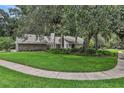 Sprawling front lawn with mature trees and landscaping, showcasing the home's curb appeal at 700 Bear Shadow Ct, Longwood, FL 32779