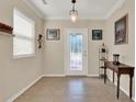 Light-filled foyer features neutral walls, tile floors, and a glass-paneled front door at 732 Wildmere Village Cv, Longwood, FL 32750