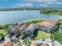 Beautiful aerial view of waterfront community with luxury homes and a tranquil lake at 7613 Toscana Blvd, Orlando, FL 32819