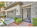 Attached garage with decorative driveway and stonework detail and secure gated entry to home at 7613 Toscana Blvd, Orlando, FL 32819