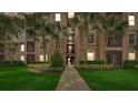 Exterior view of a condo building with palm trees and landscaped walkway at 8296 Portofino Dr # 103, Davenport, FL 33896