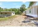 Exterior view of home with a detached garage at 9055 Atlas Dr, St Cloud, FL 34773