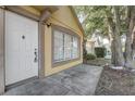 Inviting front door and window showcasing a clean facade with traditional design elements at 9447 Dearmont Ave, Orlando, FL 32825