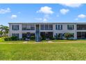 Inviting condo exterior boasting well-maintained lawns and charming architectural features at 1048 Plantation Dr # 12, Kissimmee, FL 34741