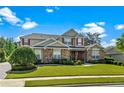 Charming two-story home with red shutters and stone accents amidst lush green lawns at 1065 Cavan Dr, Apopka, FL 32703
