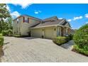 Spacious three-car garage and brick paved driveway complements this lovely home at 1065 Cavan Dr, Apopka, FL 32703