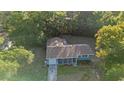 Aerial view of the house highlighting its location surrounded by lush greenery and mature trees at 1150 Virginia Avenue, Altamonte Springs, FL 32701