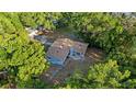 Aerial view of the home showing roof, yard, and surrounding wooded landscape at 1150 Virginia Avenue, Altamonte Springs, FL 32701