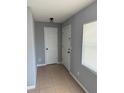 Inviting entryway with tile floors, white doors, and a window that offers natural light at 1180 Baton Dr, Deltona, FL 32725