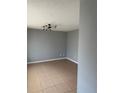 Spacious living room with tile floors and modern lighting fixture, perfect for relaxation at 1180 Baton Dr, Deltona, FL 32725