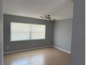 Bright living room featuring tile floors and a window that offers ample natural light at 1180 Baton Dr, Deltona, FL 32725