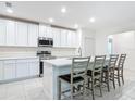 Beautiful kitchen features white cabinets, stainless appliances and a large island with seating at 1314 Victory Palm Dr, Edgewater, FL 32132