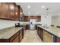 Spacious kitchen with stainless steel appliances, dark wood cabinetry, and granite countertops, ideal for cooking at 1354 Riley Cir, Deland, FL 32724