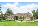Charming home with manicured lawn and tasteful landscaping, enhancing curb appeal with a welcoming entrance and inviting atmosphere at 158 Hickory Stick Ct, Debary, FL 32713