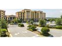 Exterior shot of the condo complex featuring manicured landscaping, gated entrance and property sign at 16300 County Road 455 # 606, Montverde, FL 34756