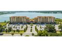 Beautiful condo buildings with lush landscaping, ample parking, and lovely surroundings, near a beautiful lake at 16300 County Road 455 # 606, Montverde, FL 34756