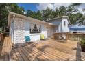 Inviting outdoor deck with ample seating space, offering a great view of the property and surrounding landscape at 201 Glenn St, Leesburg, FL 34748