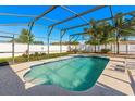 Sparkling screened pool with sunny patio, surrounded by a white privacy fence and green landscaping at 20321 Majestic St, Orlando, FL 32833