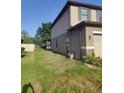 Side yard with well-maintained lawn and partial fence at 2120 Lilipetal Ct, Sanford, FL 32771