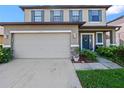 Inviting two-story home with a well-maintained lawn and a two-car garage at 2120 Lilipetal Ct, Sanford, FL 32771