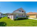 Charming home with lush landscaping, neutral color palette, and a well-manicured lawn at 2340 Hinsdale Dr, Kissimmee, FL 34741