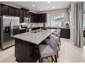 Gourmet kitchen with stainless steel appliances, granite counters, and center island with seating at 2367 Distant Sun Trl, Kissimmee, FL 34747