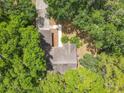Aerial view of a charming house surrounded by lush greenery and mature trees at 2647 Lake Landing Blvd, Eustis, FL 32726
