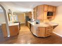Open kitchen featuring wooden cabinets, granite countertops, and stainless steel appliances, perfect for culinary enthusiasts at 361 Tulip Trl, Casselberry, FL 32707