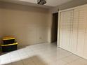 Spacious bedroom featuring tile floors and closet with shutter style doors at 4838 Pebble Beach Dr # A, Orlando, FL 32811