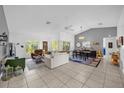 Bright, open-concept living room featuring neutral tones, tile flooring, and large windows for natural light at 4918 Gifford Blvd, Orlando, FL 32821