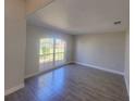 Neutral living room featuring tile flooring, a large window and light-colored walls at 506 Peace Way, Kissimmee, FL 34759