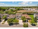 An aerial view of a charming two-story home and its neighborhood with tree lined streets at 528 Seven Oaks Blvd, Winter Springs, FL 32708