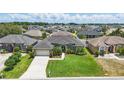 Charming home with verdant lawn and landscaping in a neighborhood with sidewalks at 6758 Hillis Dr, Lakeland, FL 33813