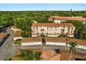 Aerial view of condos, garages, and landscaping in a well-maintained community at 676 Sandy Neck Ln # 102, Altamonte Springs, FL 32714