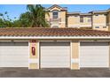 Garage unit with white doors under a clay tile roof at 676 Sandy Neck Ln # 102, Altamonte Springs, FL 32714