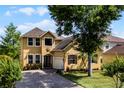 Charming two-story home with a well-maintained lawn and beautiful landscaping at 724 Wildmere Village Cv, Longwood, FL 32750