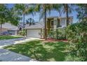 Beautiful home with a two-car garage, well-manicured lawn, mature trees, and inviting curb appeal at 821 N Lake Claire Cir, Oviedo, FL 32765