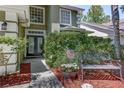 Inviting front entrance with double doors, decorative plants, and a charming bench at 821 N Lake Claire Cir, Oviedo, FL 32765