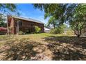 Expansive backyard with a two-story deck and mature trees providing ample shade at 825 Mellowood Ave, Orlando, FL 32825