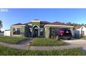 Well-manicured lawn with a single-story home, car parked in the driveway, and attached garage at 8325 Sun Vista Way, Orlando, FL 32822