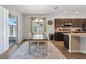 Bright dining area with sliding glass doors and modern chandelier lighting at 1052 Cascade Dr, Davenport, FL 33837