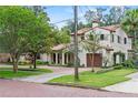 Elegant two-story home showcasing stucco exterior, tile roof, and driveway at 1110 Greenwood St, Orlando, FL 32801