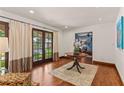 Beautiful foyer with hardwood floors, glass French doors, and a round wood table at 1110 Greenwood St, Orlando, FL 32801