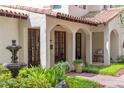 Inviting front porch with arched entryways, water fountain, and manicured garden at 1110 Greenwood St, Orlando, FL 32801
