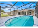 Inviting screened-in pool area with a sparkling pool, patio, and views of the backyard at 114 Dolcetto Dr, Davenport, FL 33897