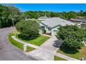 Aerial view of a charming home featuring mature trees, lush lawn, and a well-maintained exterior in a serene neighborhood at 1157 Valley Creek Run, Winter Park, FL 32792