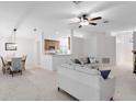 Bright, open living room featuring neutral colors, carpet floors, and access to dining area at 1174 Snug Harbor Dr, Casselberry, FL 32707