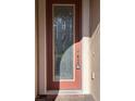 Close-up of an ornate front door featuring decorative glass and a secure lock with a key at 11962 Autumn Fern Ln, Orlando, FL 32827