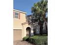 Charming two-story home showcases a tile roof, an arched entryway, manicured landscaping, and a two-car garage at 11962 Autumn Fern Ln, Orlando, FL 32827